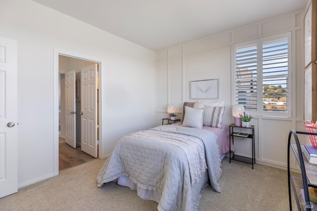 carpeted bedroom with baseboards