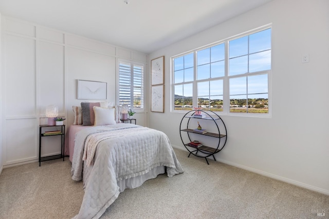 carpeted bedroom featuring baseboards