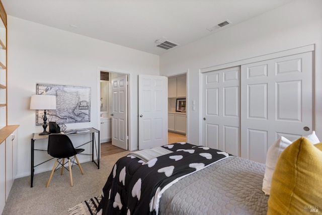 bedroom featuring baseboards, visible vents, a closet, and light colored carpet