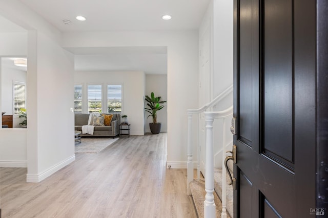 foyer featuring recessed lighting, light wood-style flooring, and baseboards