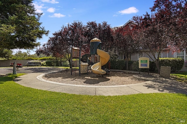 community jungle gym featuring a lawn
