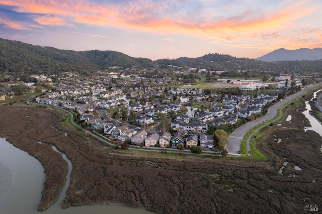 aerial view at dusk with a residential view and a water and mountain view