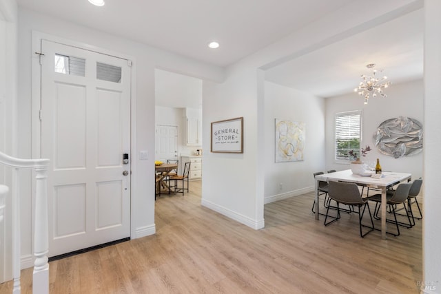 entryway with recessed lighting, baseboards, a chandelier, and light wood-style flooring