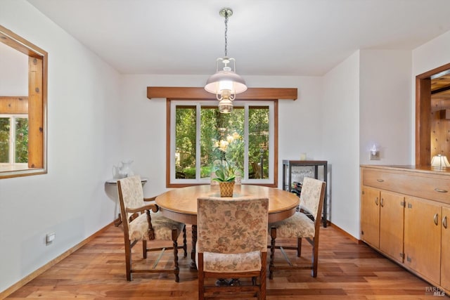 dining room with light wood finished floors and baseboards