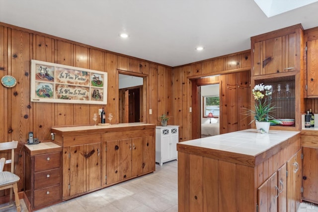 kitchen with tile countertops and brown cabinetry
