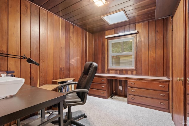 office area featuring light colored carpet, wood ceiling, and wood walls