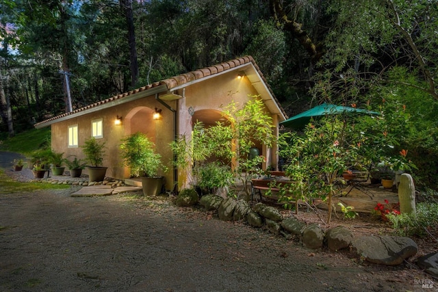 view of home's exterior featuring a tiled roof and stucco siding