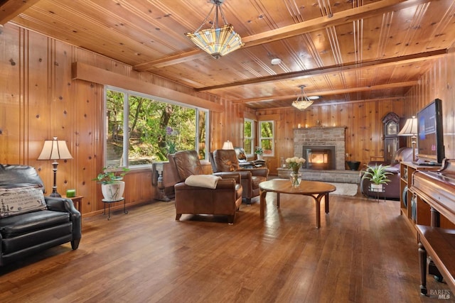 living room with hardwood / wood-style floors, beamed ceiling, wooden walls, and wood ceiling