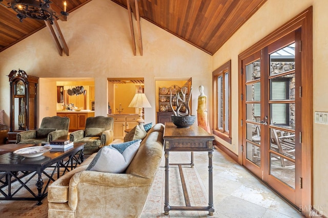 living room featuring wooden ceiling, beam ceiling, high vaulted ceiling, and baseboards