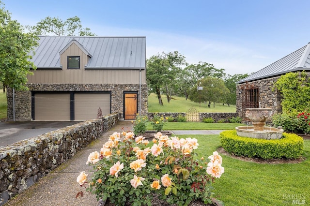 view of front of property featuring metal roof, a standing seam roof, stone siding, and a front lawn