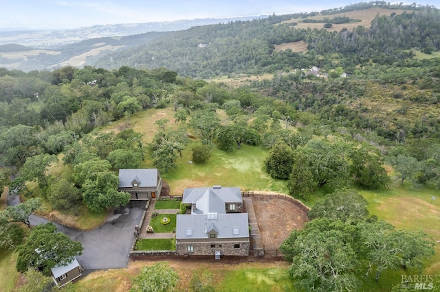 birds eye view of property featuring a mountain view and a forest view