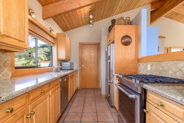 kitchen featuring backsplash, a sink, lofted ceiling with beams, and appliances with stainless steel finishes