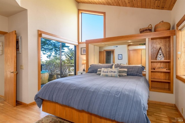 bedroom featuring baseboards, access to exterior, wood finished floors, and wooden ceiling