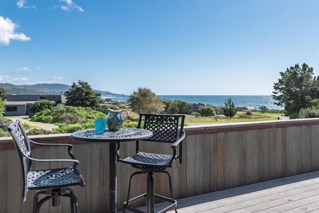 wooden deck featuring a water view