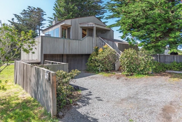 contemporary house featuring fence