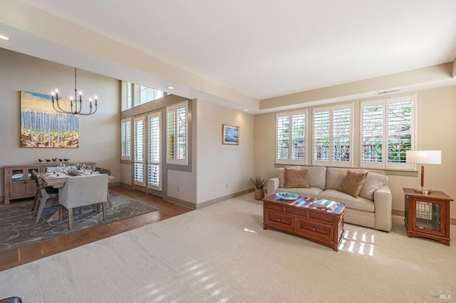 carpeted living area with a chandelier, recessed lighting, and baseboards