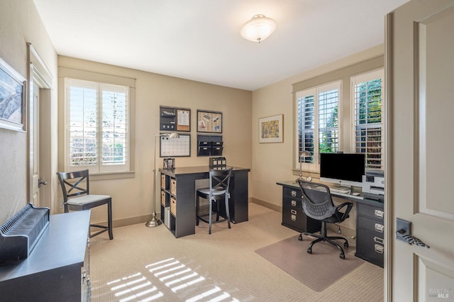 carpeted office space featuring baseboards
