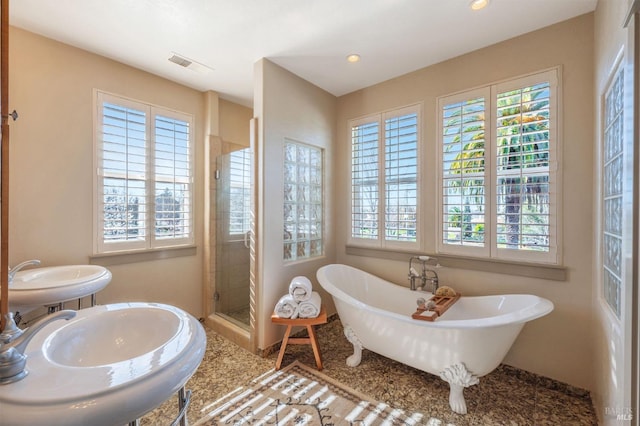 full bathroom featuring a stall shower, recessed lighting, visible vents, and a soaking tub