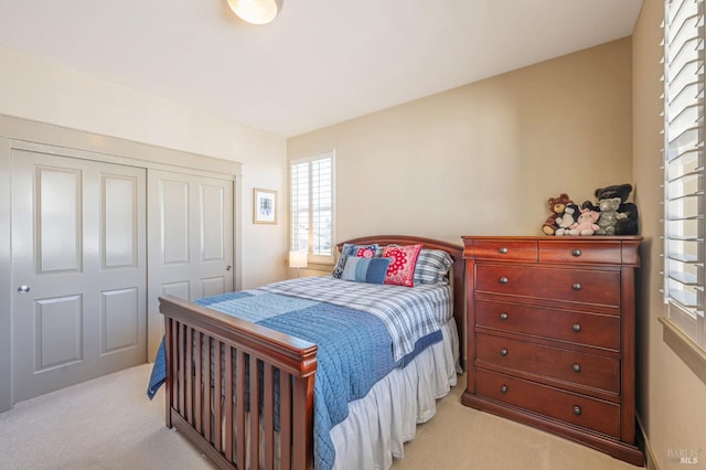 bedroom with a closet and light carpet