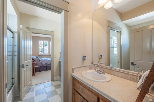 full bath featuring tile patterned floors, ensuite bathroom, and vanity
