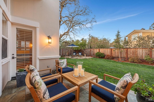 view of patio featuring an outdoor living space and a fenced backyard