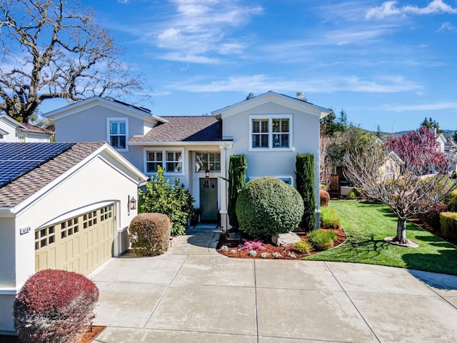 view of front of home featuring a garage, stucco siding, driveway, and a front yard
