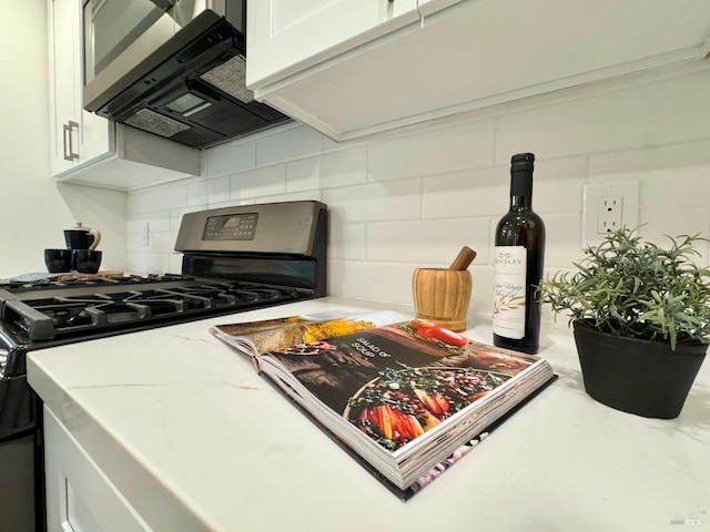 2131 1st Ave, Napa, CA 94558 - kitchen featuring white cabinets, light stone counters, tasteful backsplash, and stainless steel appliances