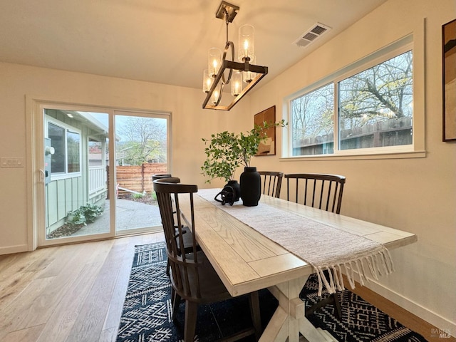 2131 1st Ave, Napa, CA 94558 - dining space with light wood finished floors, visible vents, baseboards, and an inviting chandelier
