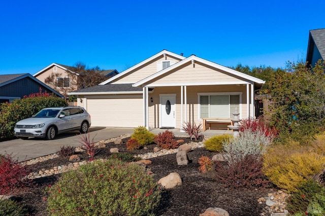 view of front of house with concrete driveway, a porch, and a garage