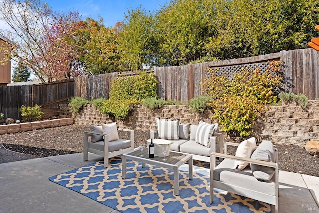 view of patio featuring an outdoor living space and a fenced backyard