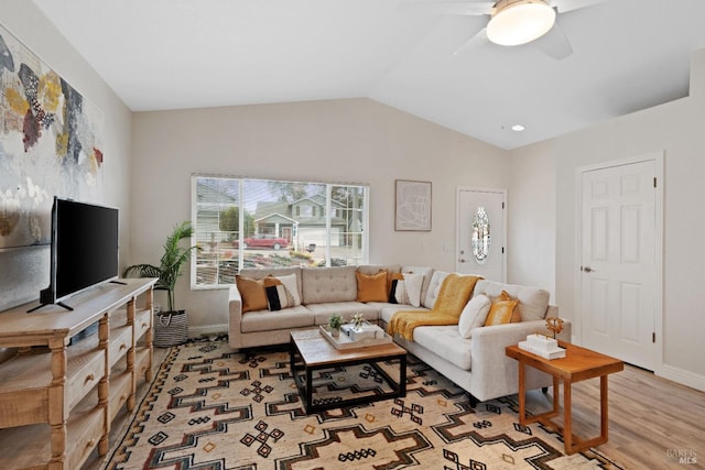 living room featuring lofted ceiling, plenty of natural light, a ceiling fan, and wood finished floors