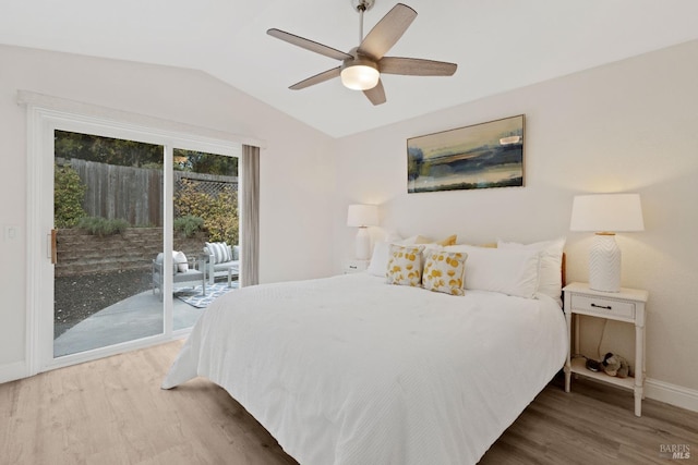 bedroom with a ceiling fan, access to outside, wood finished floors, baseboards, and vaulted ceiling