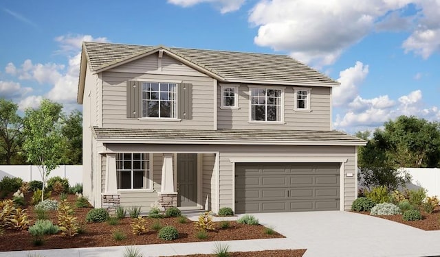 traditional-style home featuring an attached garage, fence, and concrete driveway