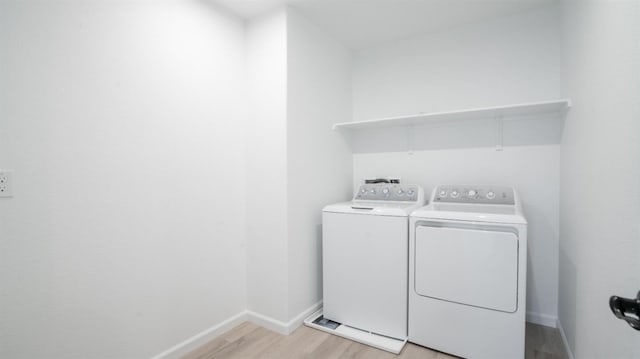1059 Jarup Dr, Lathrop, CA 95330 - washroom featuring washer and clothes dryer, baseboards, laundry area, and light wood-style flooring