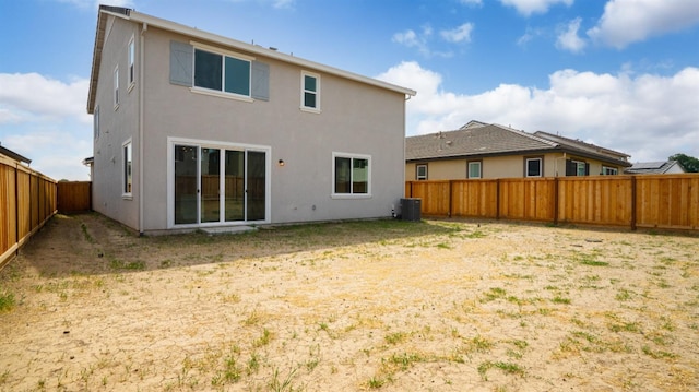1059 Jarup Dr, Lathrop, CA 95330 - back of house featuring central AC, a fenced backyard, and stucco siding