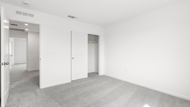 unfurnished bedroom featuring visible vents, baseboards, and carpet floors