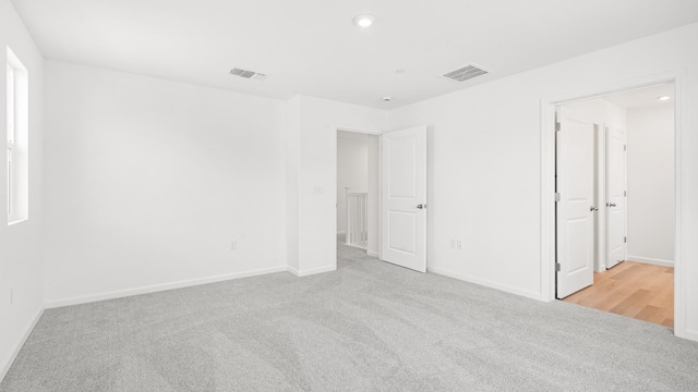 unfurnished bedroom featuring baseboards, visible vents, and carpet floors