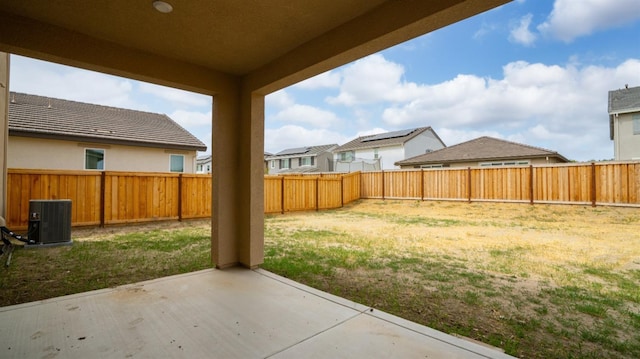 view of yard with central AC unit, a patio area, a residential view, and a fenced backyard