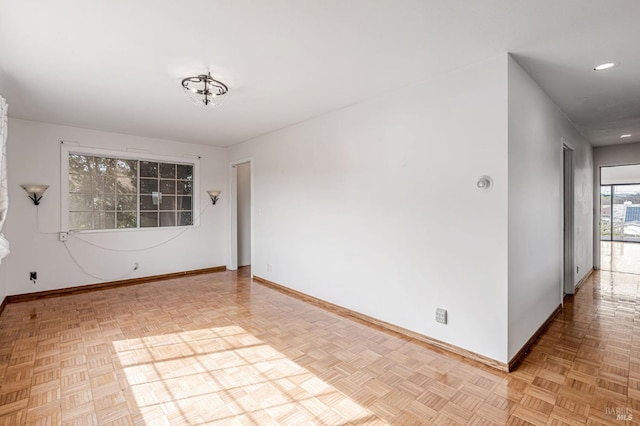 empty room with recessed lighting and baseboards
