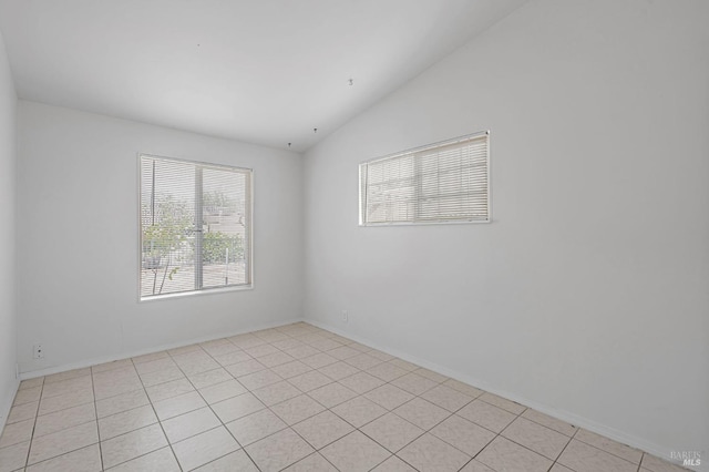 spare room featuring lofted ceiling
