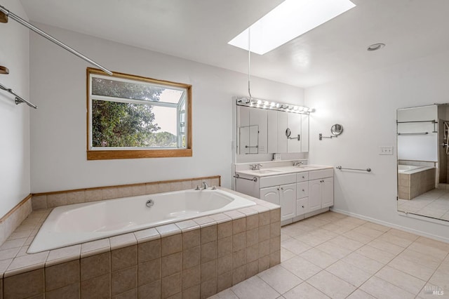 bathroom featuring tile patterned floors, a garden tub, a sink, a skylight, and double vanity