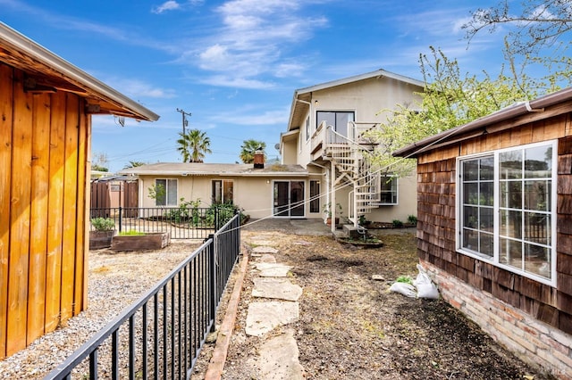 back of house featuring fence
