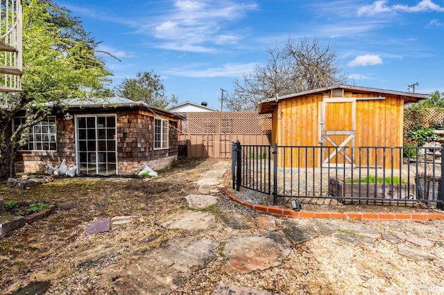 view of yard featuring an outdoor structure and fence