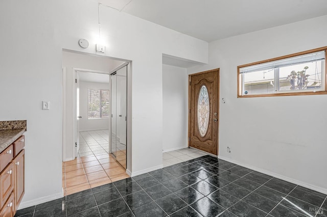 tiled entryway featuring baseboards