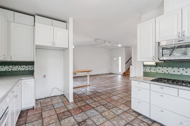 kitchen with light countertops, white cabinets, and appliances with stainless steel finishes
