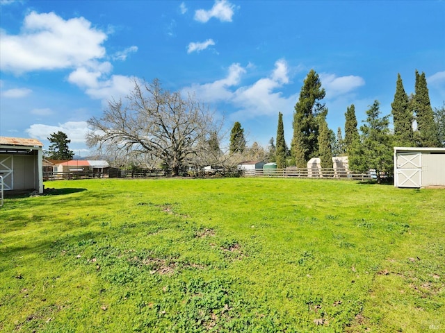 view of yard featuring a rural view and fence