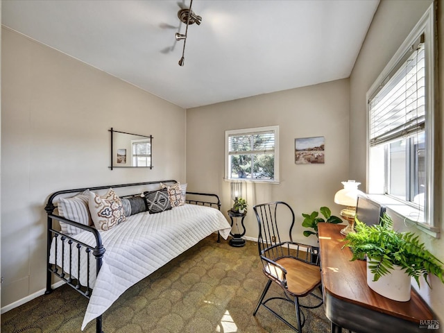 bedroom featuring baseboards and carpet