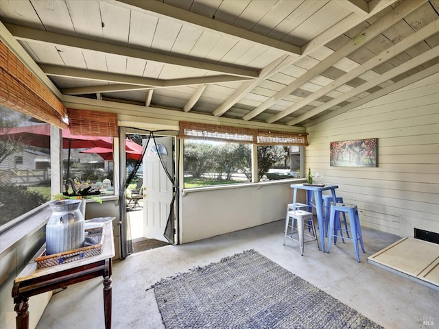 sunroom / solarium featuring beam ceiling