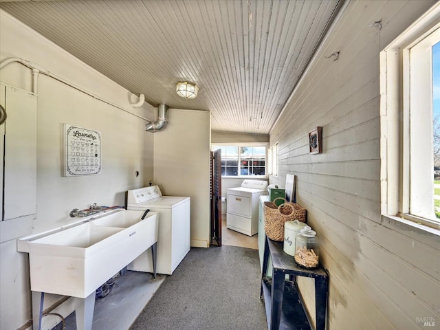 laundry room featuring a sink, separate washer and dryer, a healthy amount of sunlight, and laundry area