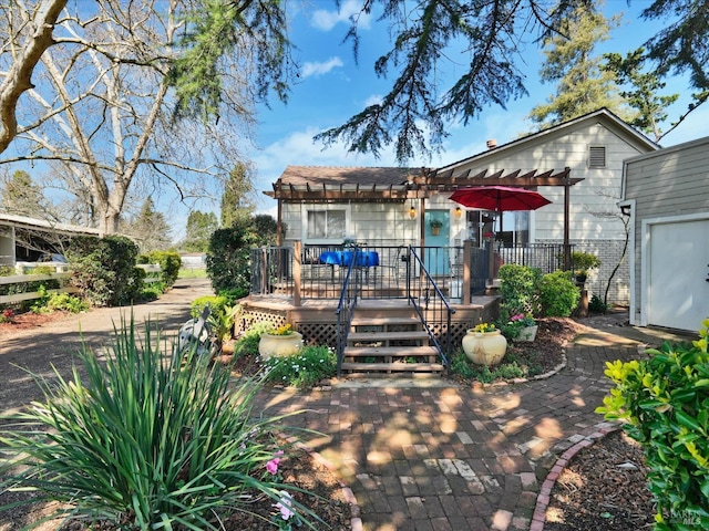 back of house with a deck and a pergola